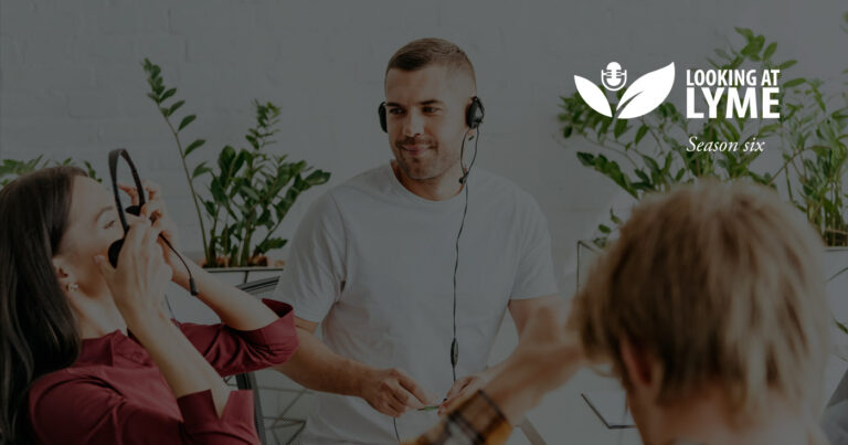 A team of podcasters sit together listening to a take and talking it through.